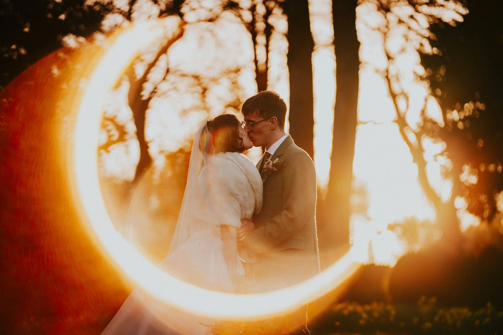 Magical light amidst the daffodils of this Springtime wedding at Wortley Hall Sheffield. The Bride and Groom kiss surrounded by golden hour magic.