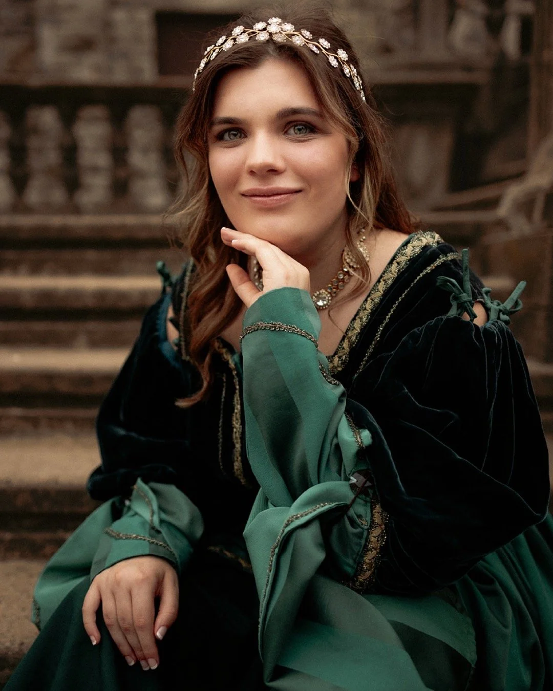 Some seniors show up with a vibe. And then some arrive with a vision.

For this part of her session, she dreamed of something grand and Renaissance-inspired &mdash; an enormous staircase, a sweeping gown, drama in every fold of fabric. And honestly, 