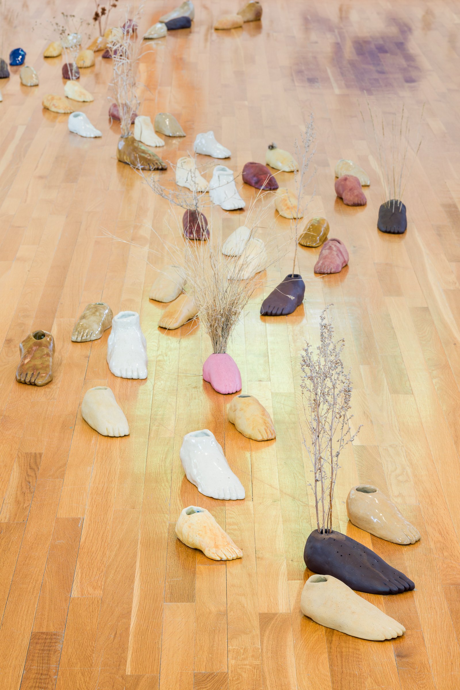  Installation view of  Gathering near and far, still  by April Matisz showing  Walking landscape , ceramics and plant materials, 2020-2023. Courtesy of the artist. Photo by Blaine Campbell. 