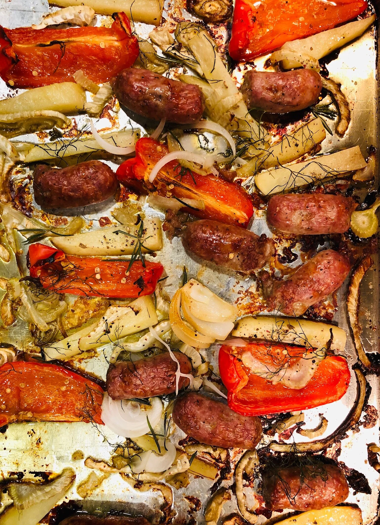 This weeknight sheet-pan meal was made with Italian sausages, red peppers, fennel and onion.