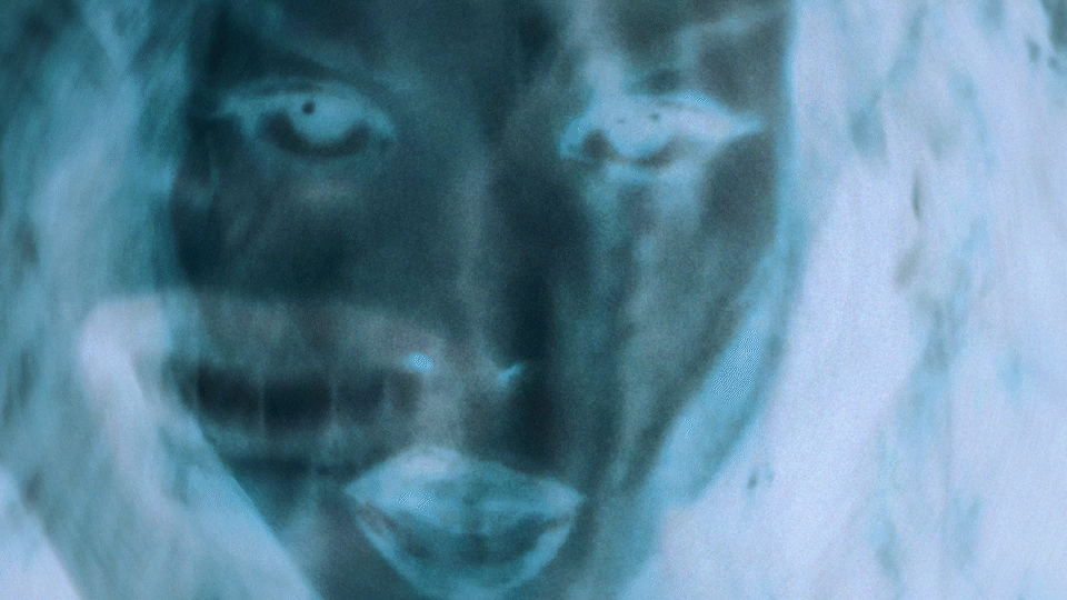 Danna cover for her song Amor Acido. Shot by Rafael Arroyo Director and DP based in NY  Close-up of a person's face with a negative filter effect, showing eyes, nose, and mouth. Popstar lighting. Creative Effects