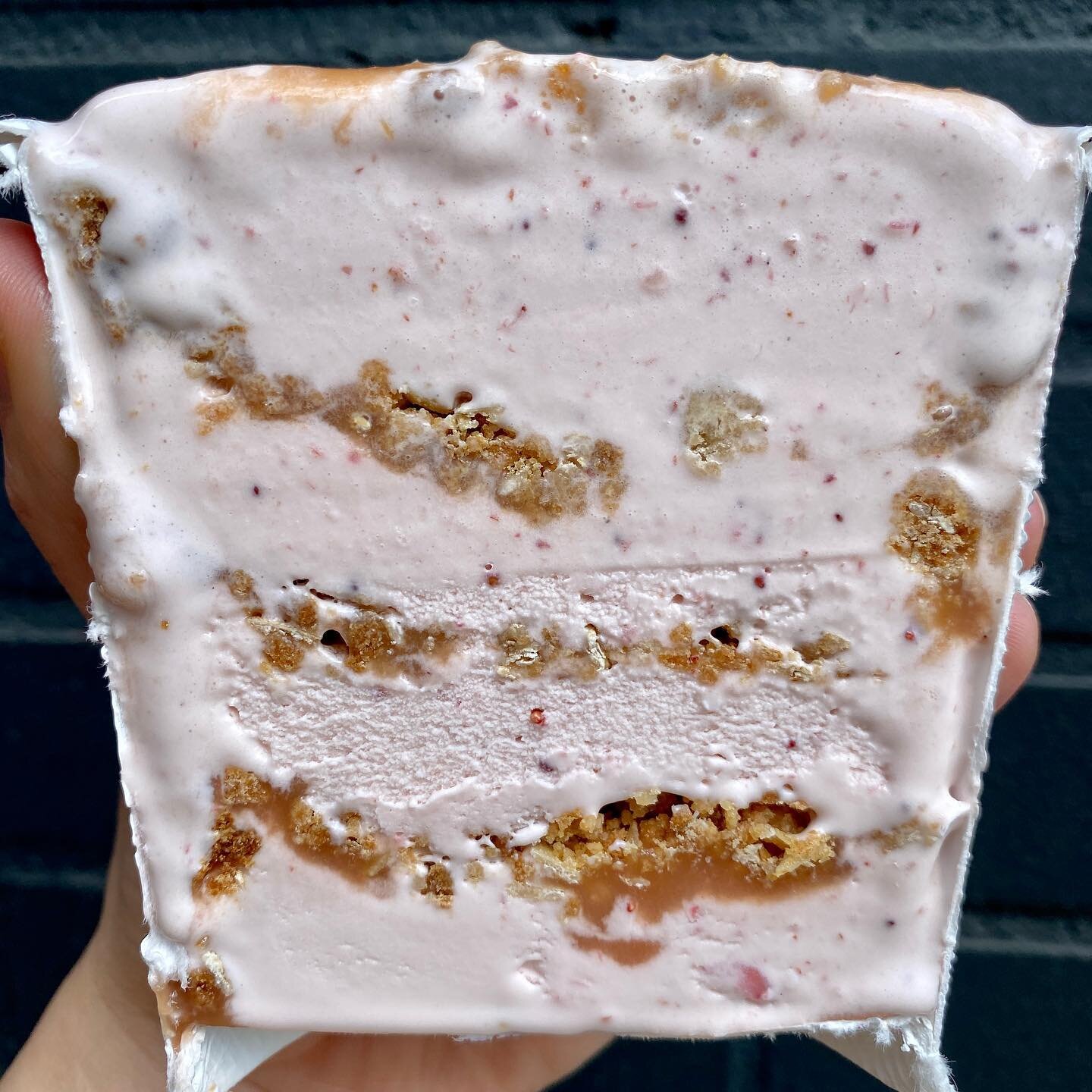 Cross shot of a pint of our Strawberry Rhubarb Crisp! We spent all day making this flavor for you guys!!

Strawberry ice cream, rhubarb jam, toasted oat crumble deliciousness. 🍓Oh yeah, we&rsquo;ve got a vegan version, too. 😋

Swing by for scoops a