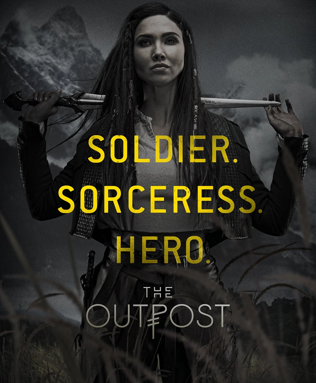 Poster of a woman with long dark hair, holding a baseball bat over her shoulders, standing in a dark, stormy outdoor setting with tall grass in the foreground. Text on the poster reads 'Soldier. Sorceress. Hero. The Outpost.'