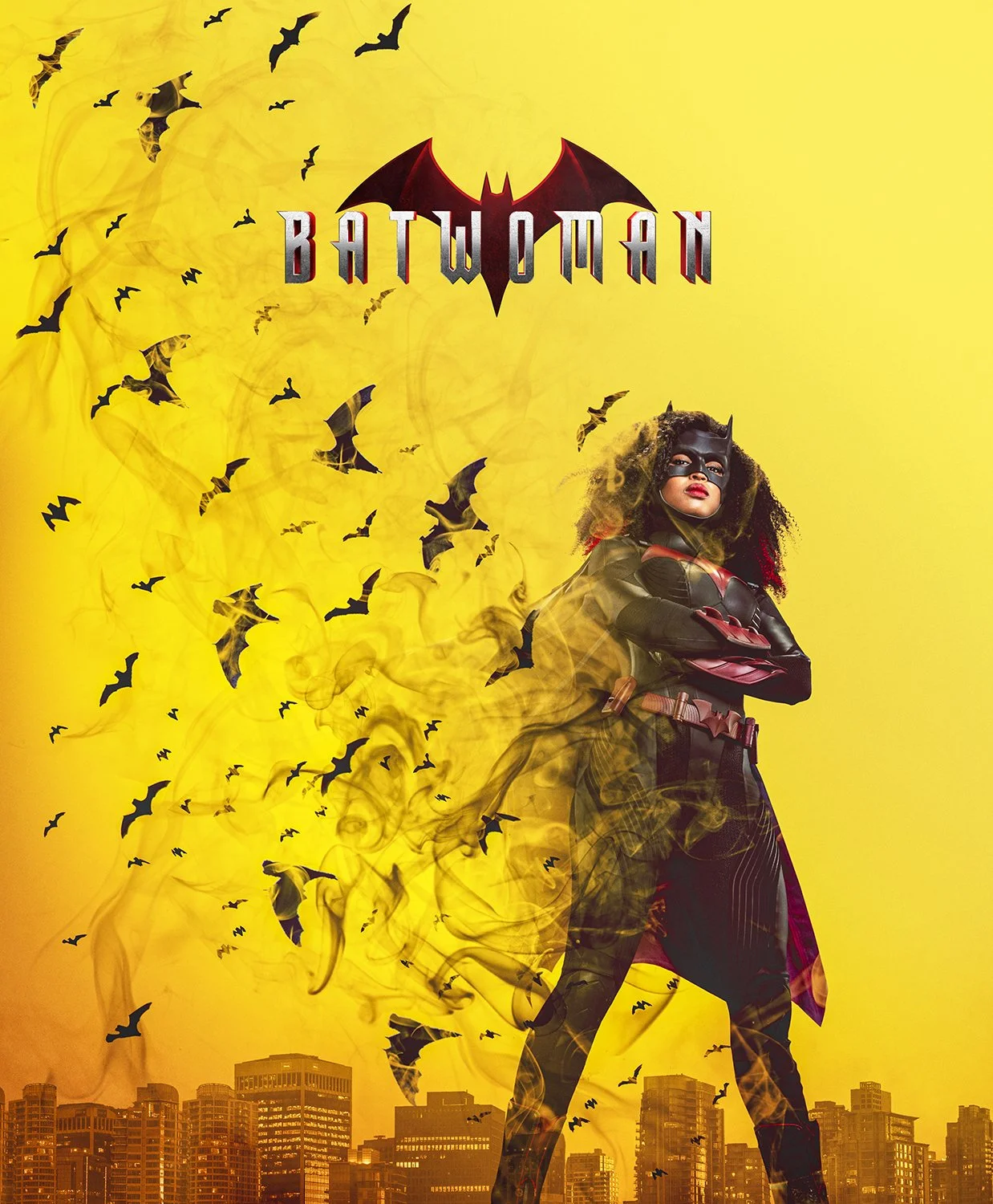 A promotional poster for the movie Batwoman shows a woman dressed as Batwoman standing with arms crossed in front of a yellow background with flying bats and a city skyline at the bottom.