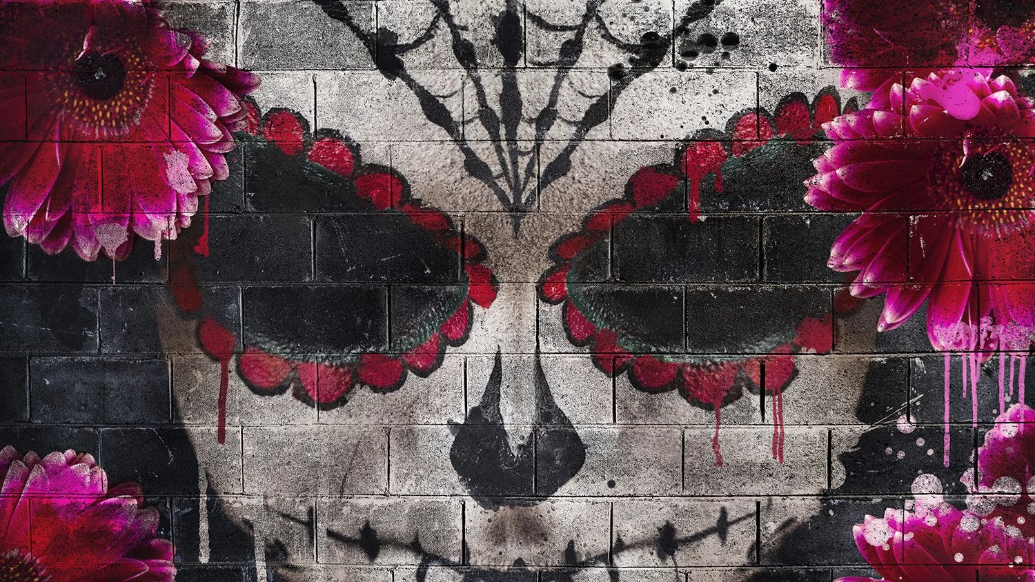 Graffiti of a butterfly skull with pink flowers on a brick wall.