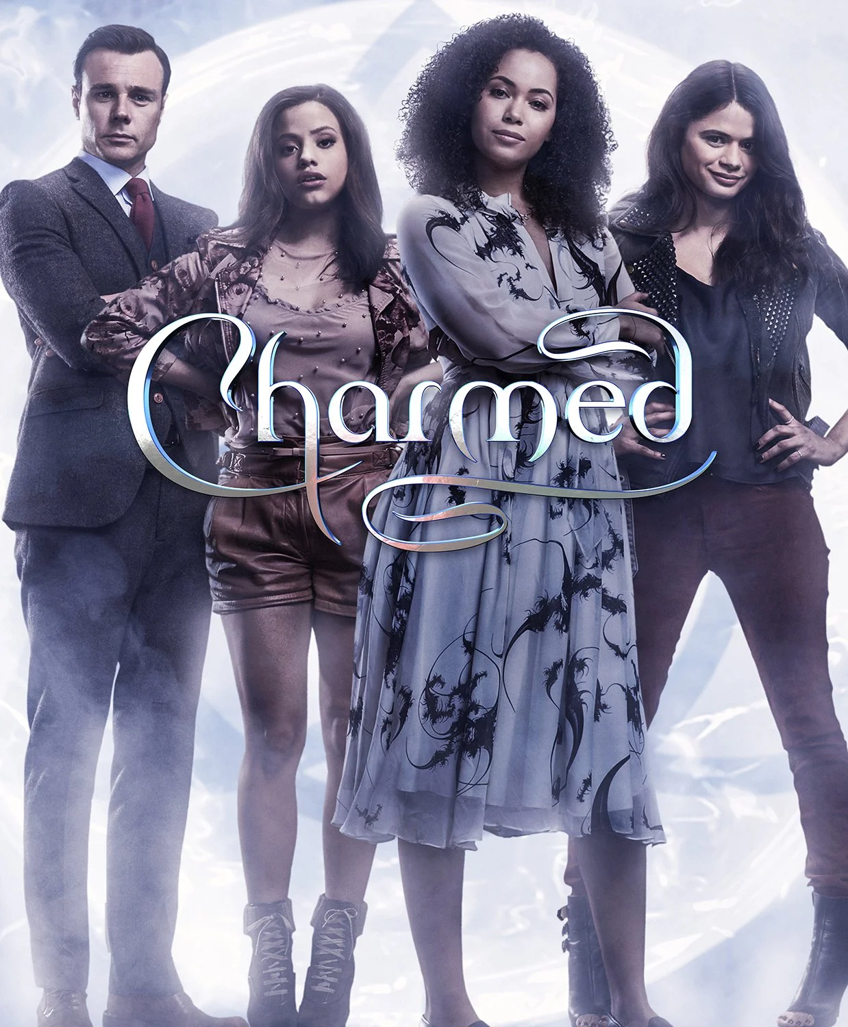 Four women and one man stand with crossed arms in front of a sci-fi background, with the word 'Charmed' overlaid.