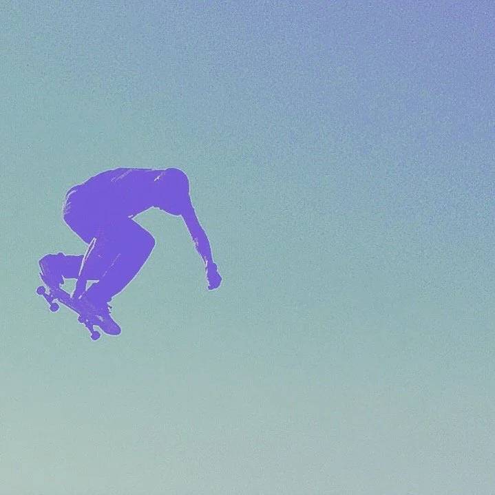 Silhouette of a skateboarder mid-air against a light blue sky.