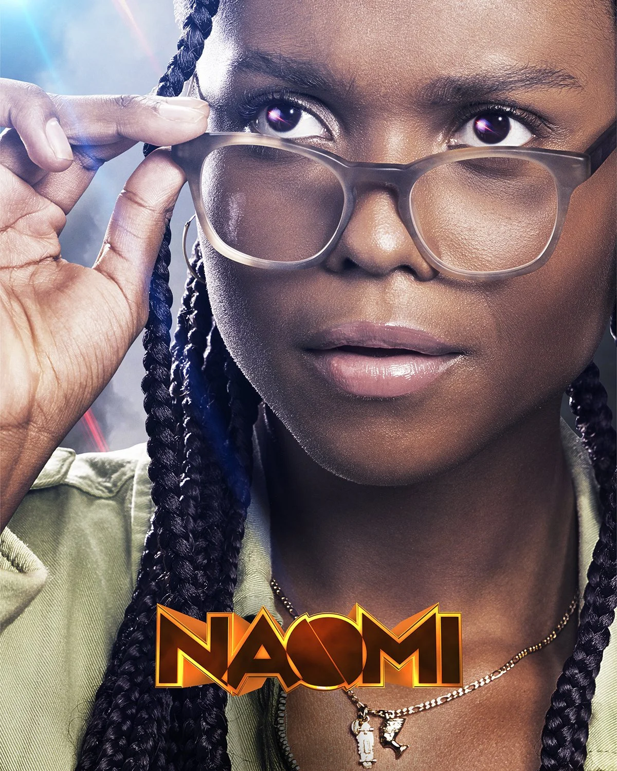 Close-up of a woman with braided hair, wearing glasses and a green jacket, with a confident expression. The word 'NAOMI' appears at the bottom in bold, stylized text.