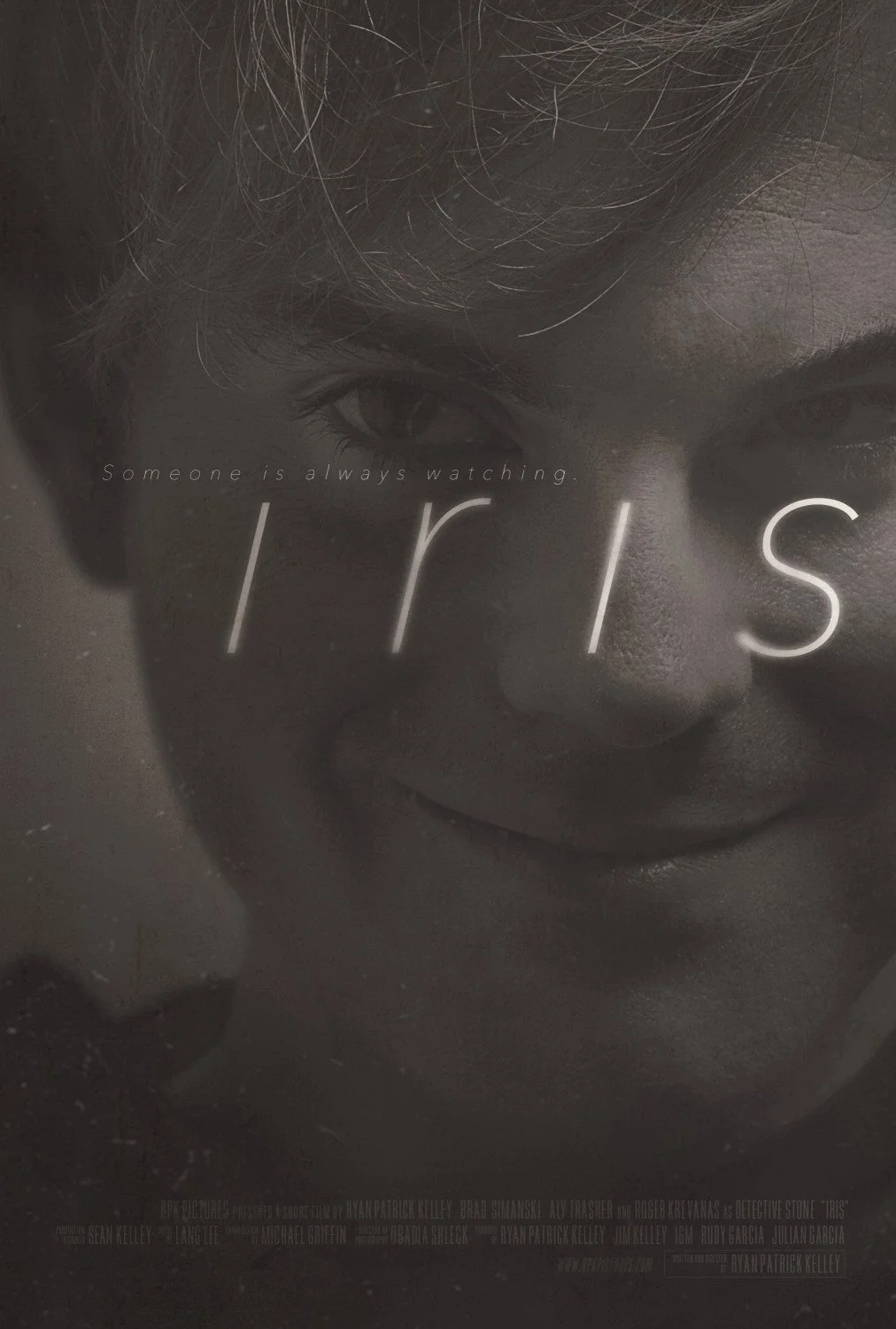 Close-up of a face of a woman with an intense expression, with the film title 'IRIS' and the tagline 'Someone is always watching' overlaid in white text.