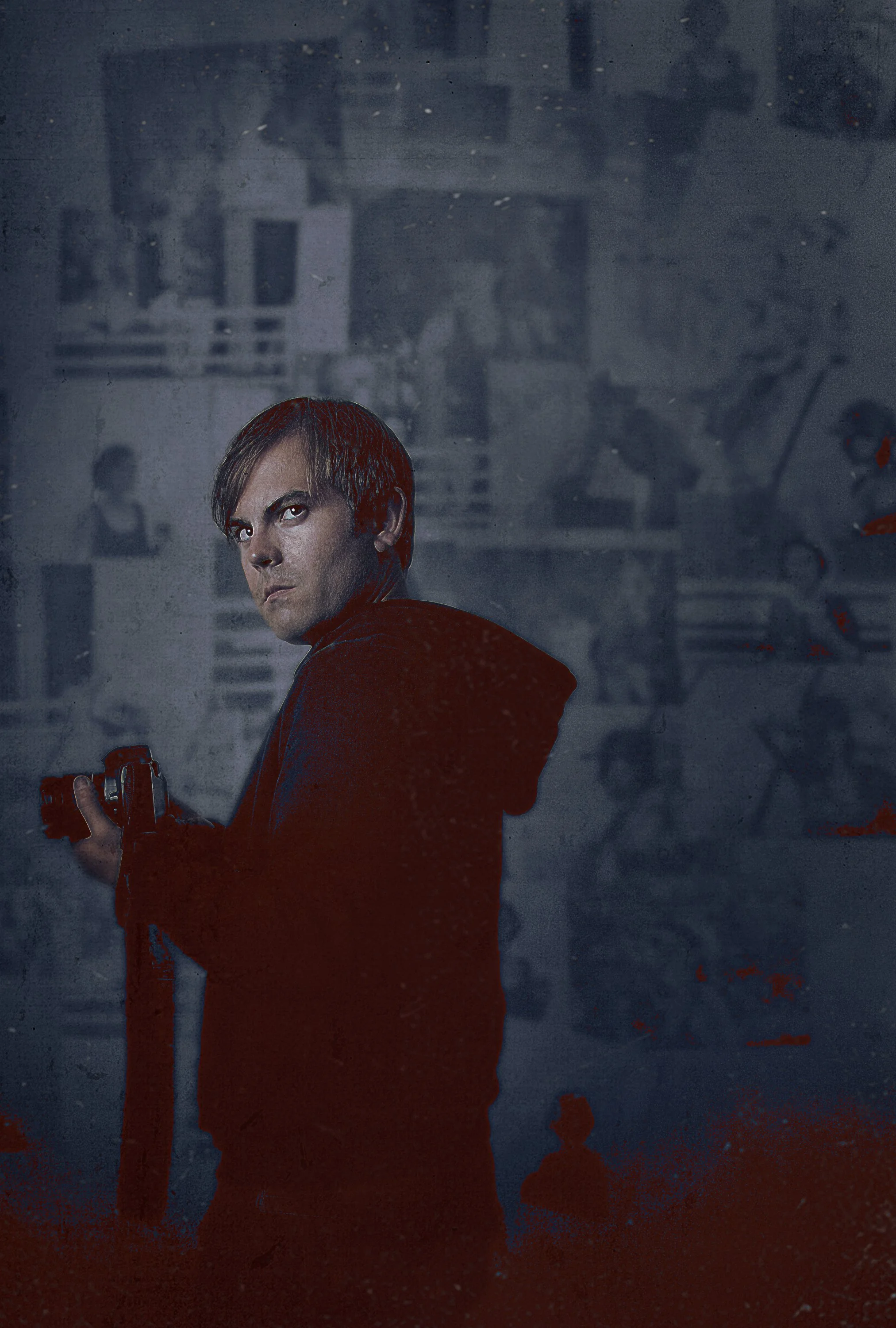 A man with brown hair holding a gun, looking over his shoulder in a gritty urban environment.