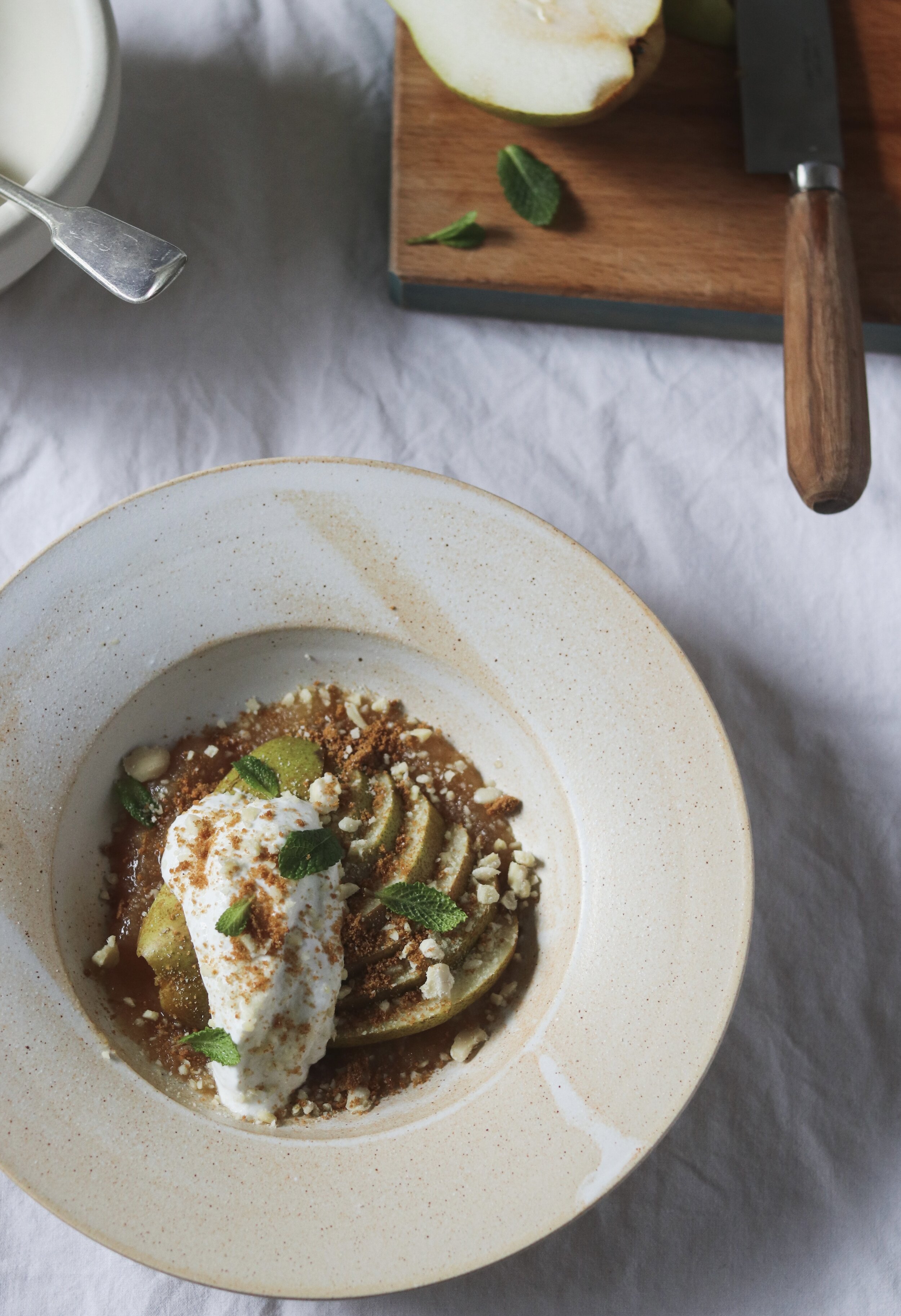 Sliced pears with pear compote, goats curd and Biscoff hazelnut crumb