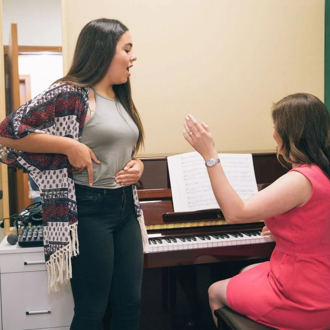 Student receiving 1-to-1 LAMDA Musical Theatre and vocal coaching with a tutor at the piano.