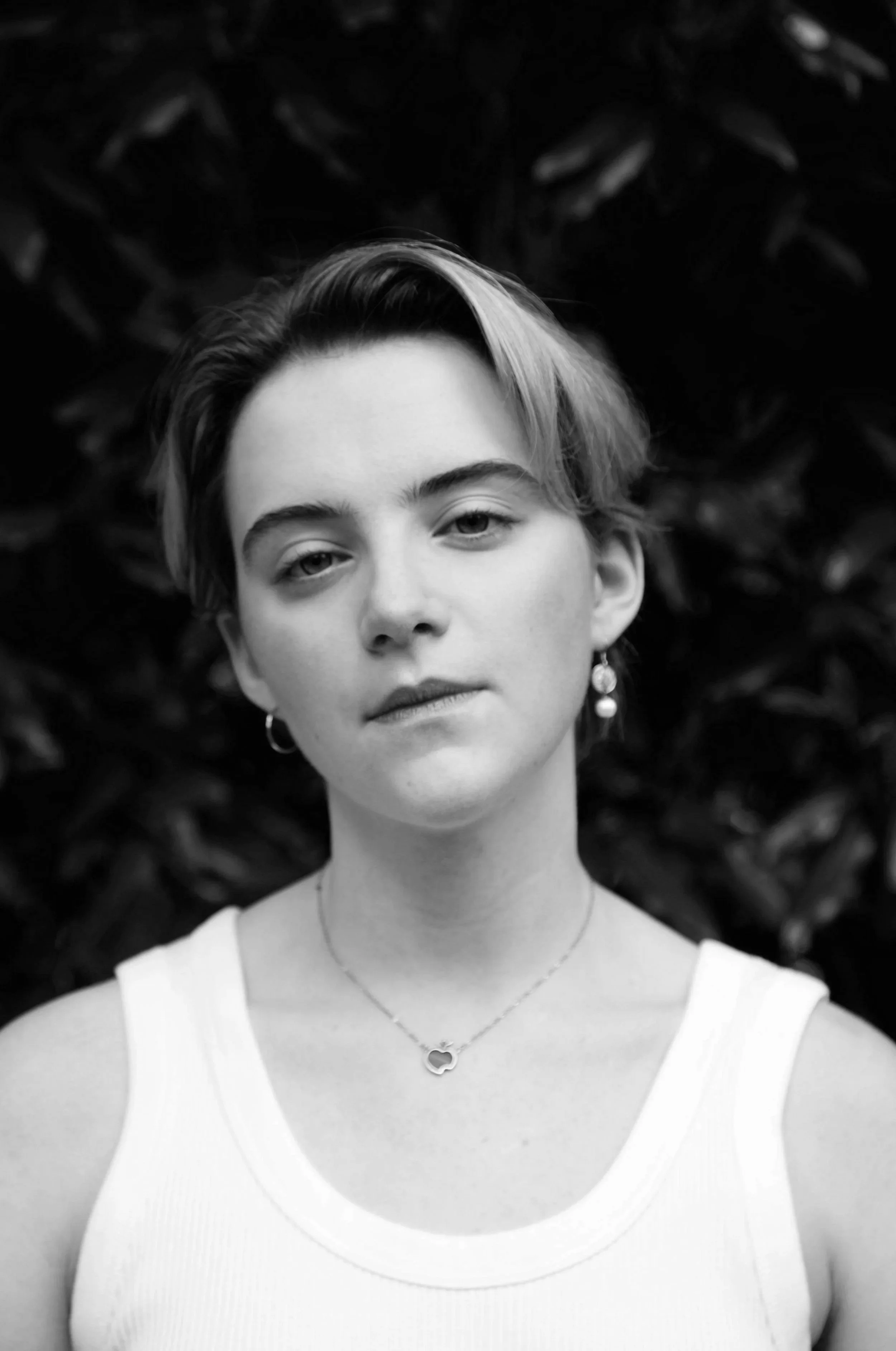 An A-Level drama tutor stands against a black background