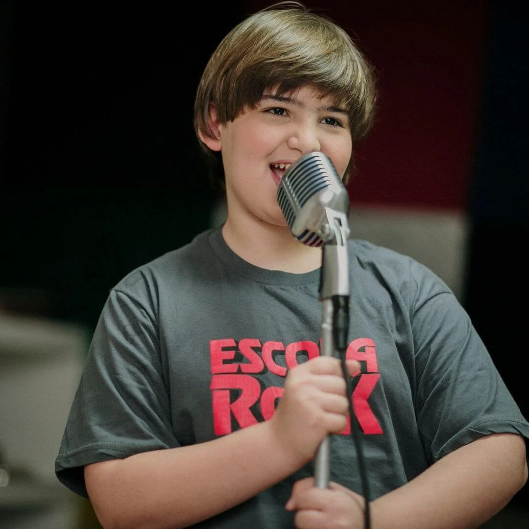 Student practicing public speaking and acting skills into a microphone during LAMDA exam tuition with U2 Tuition..