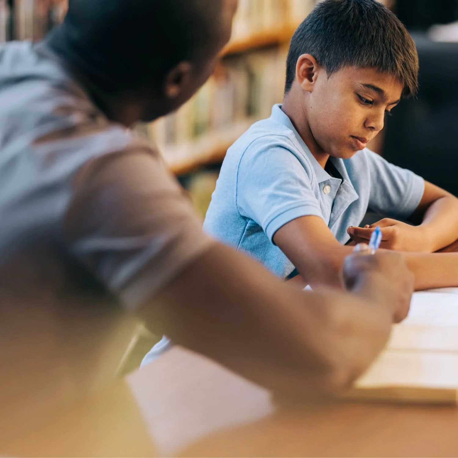 A U2 student works on the KCJS 8+ English exam with a U2 Tutor.