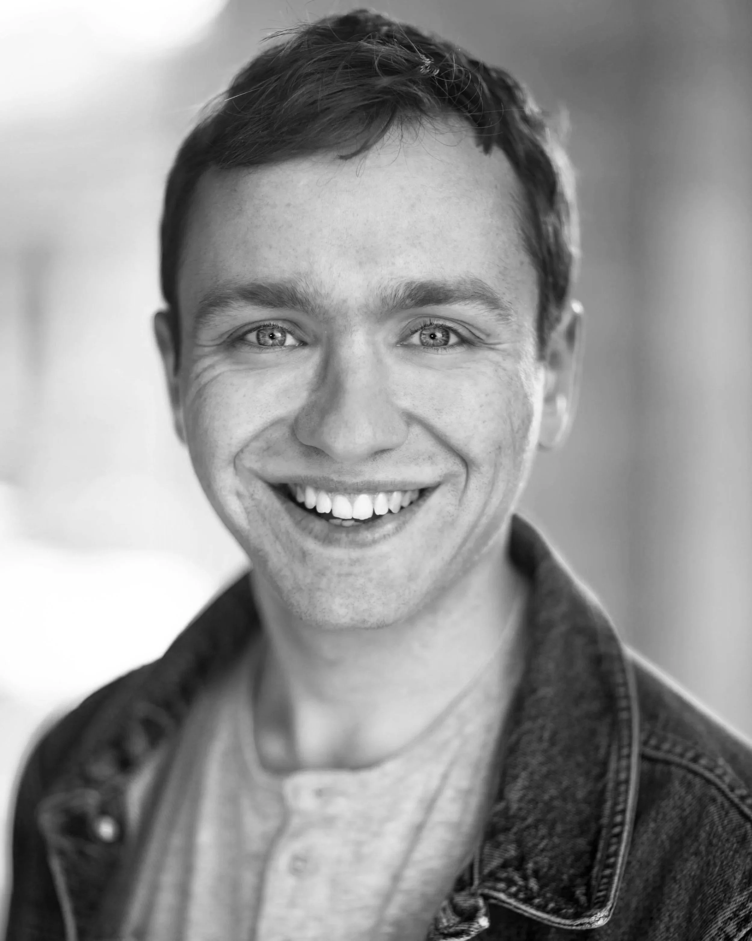 An A-Level drama tutor stands against a white background