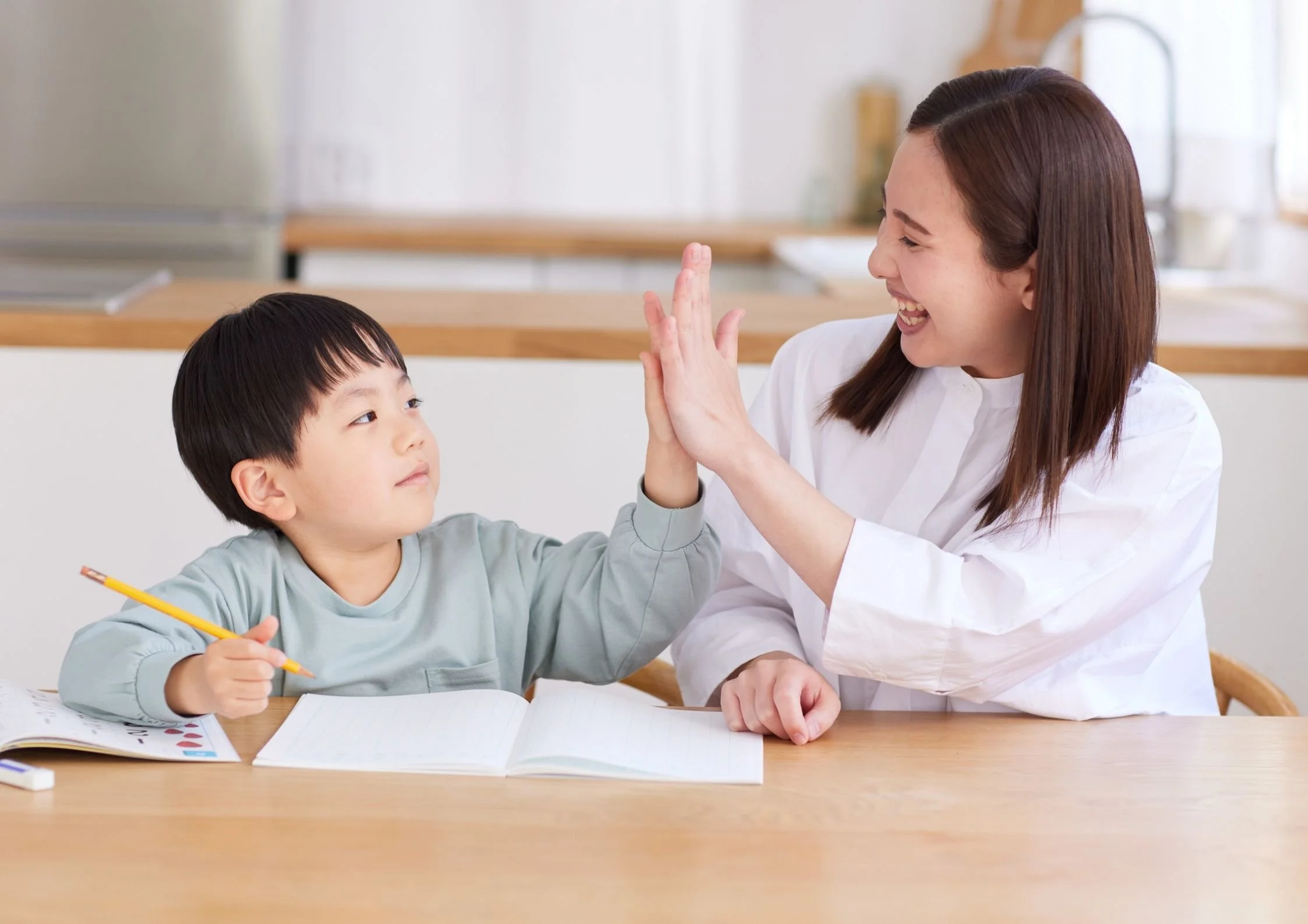 A U2 tutor helps a U2 student with reading comprehension practice for the 11+ examinations