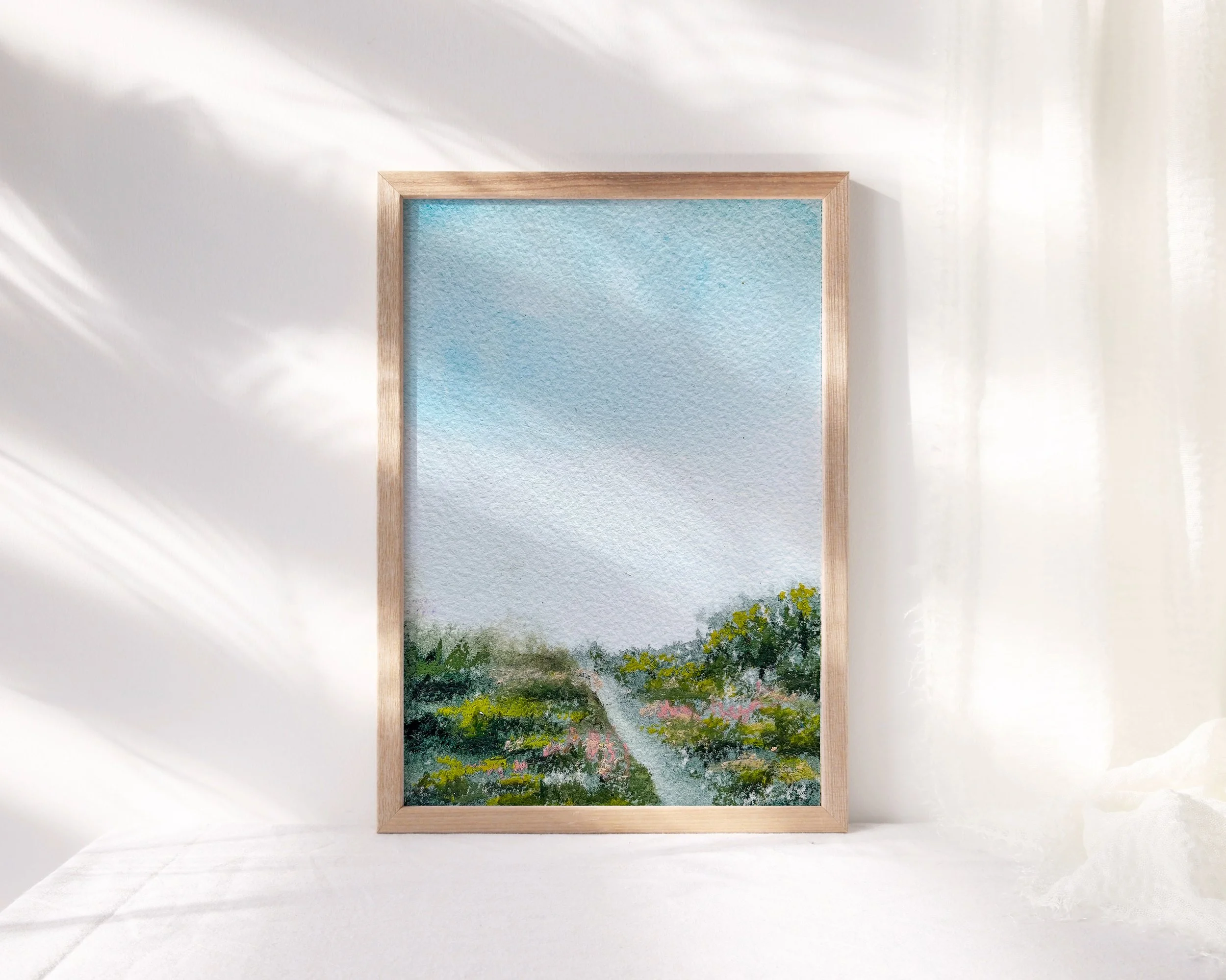 Meadow landscape painting under a blue sky. Expressive pastel wildflowers on a watercolor background.