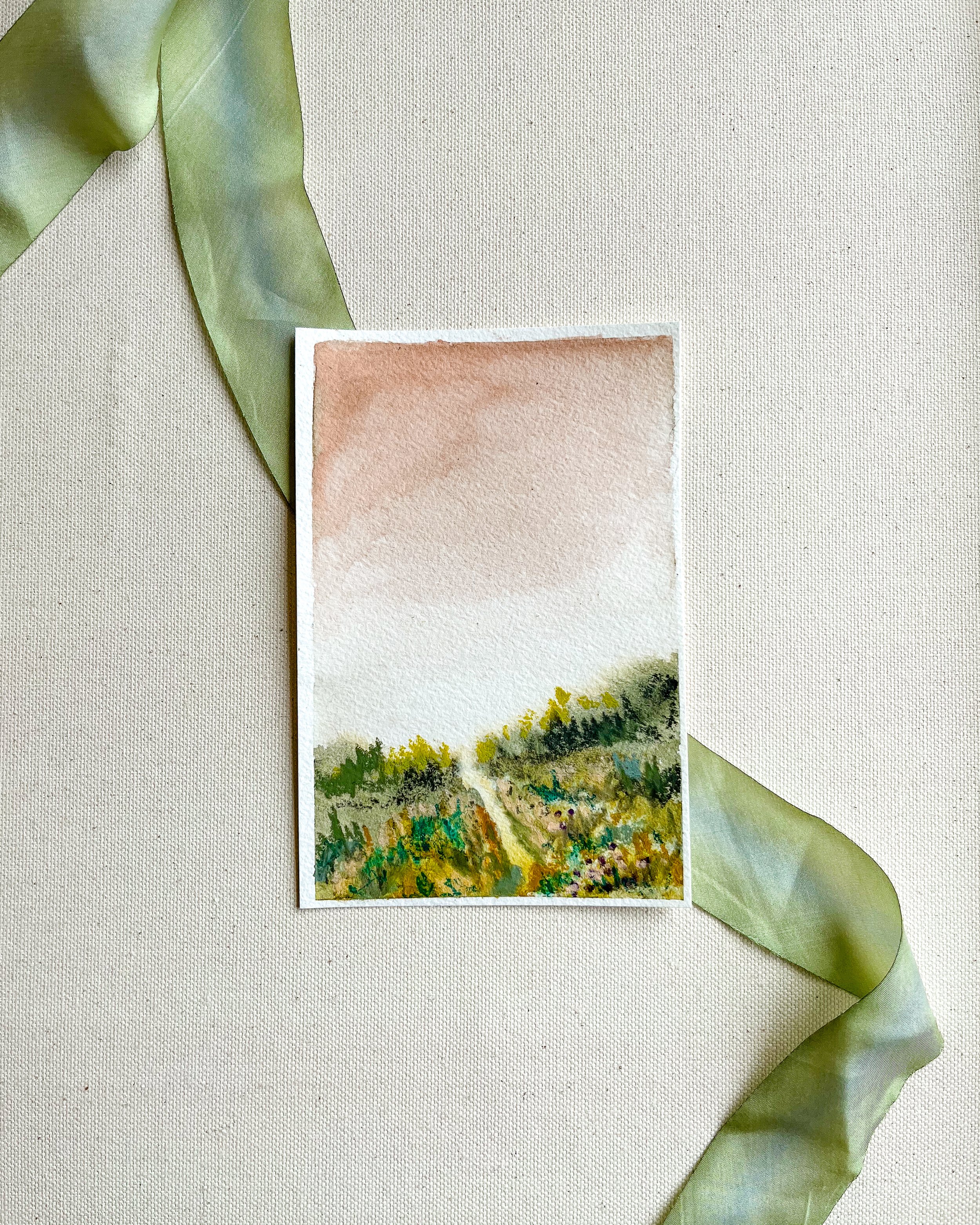 Mixed media watercolor and pastel landscape painting on canvas background with green silk ribbon