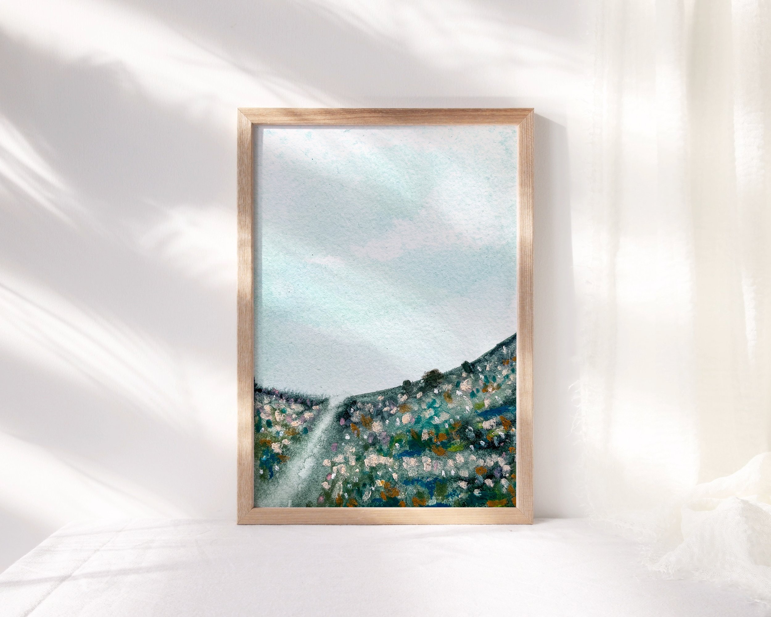 Blue abstract mixed media landscape painting shown in minimalist wood frame