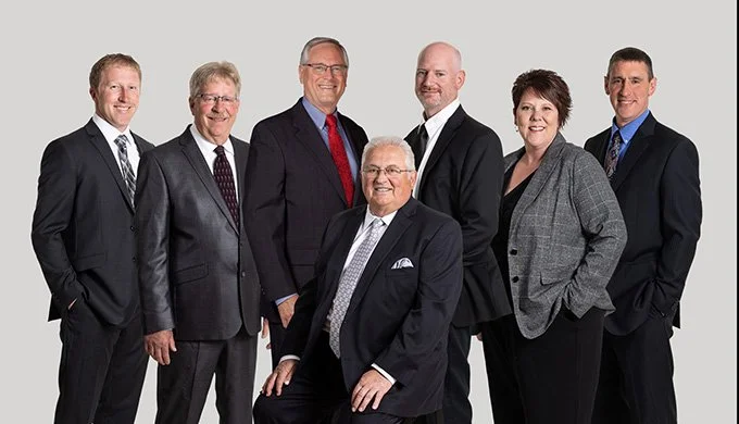 Bank boards and other teams can be photographed individual and composited together.  This means not everyone has to be present at the same time and it is easier to update your team picture when a new team member comes in.