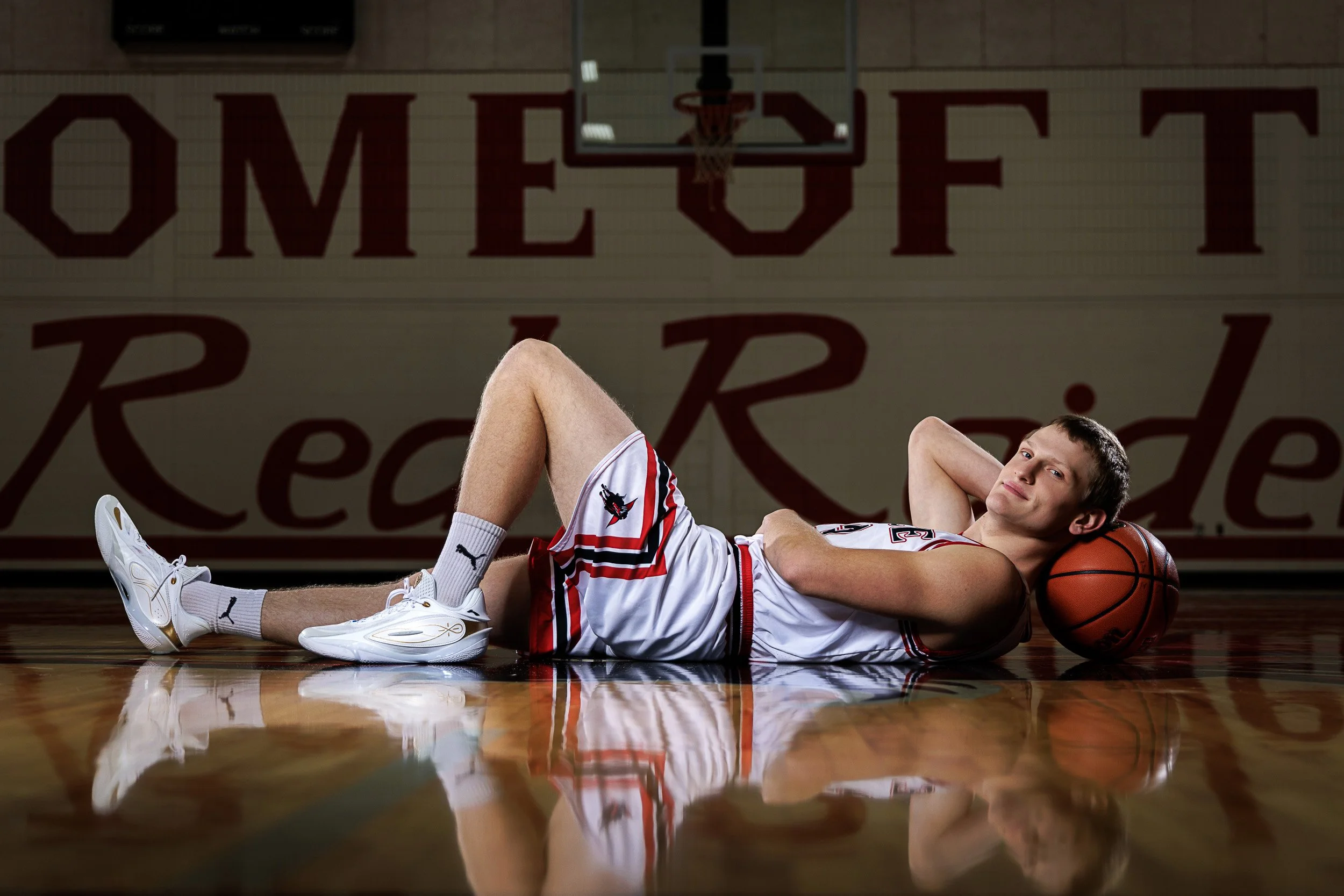 Senior portraits of a basketball player in his home gym in Bruce, WI by Seasons Photography.