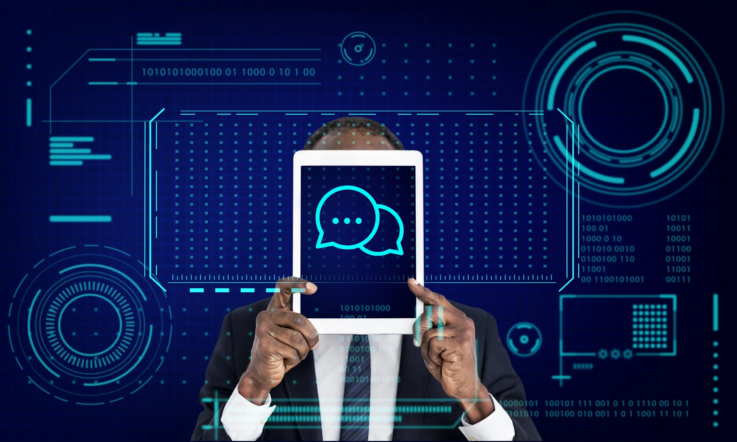 A person in a business suit holding a tablet that displays a speech bubble icon, with digital futuristic interface graphics and binary code in the background.