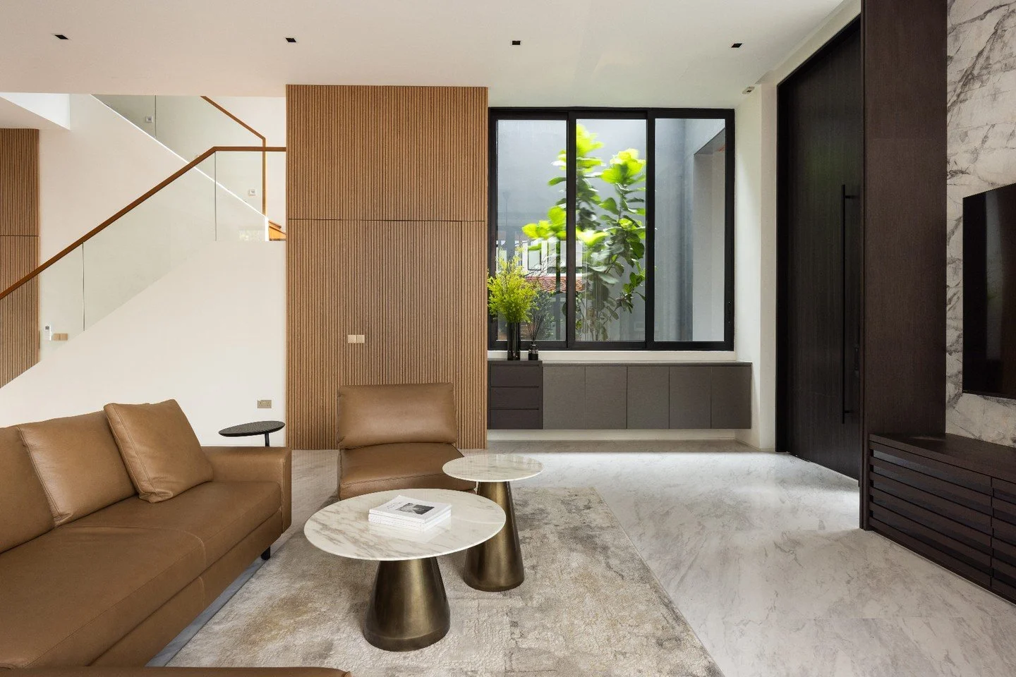 The ground level communal area at Skyville opens to the exterior along both lengths, including the shared party wall of the semi-detached dwelling - the detachment of the building volume allowed for a landscaped courtyard that brought light and venti