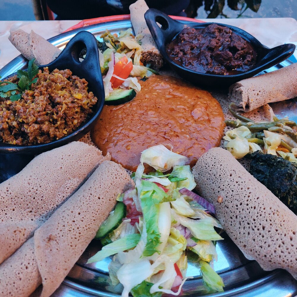 Sharing dish with injera