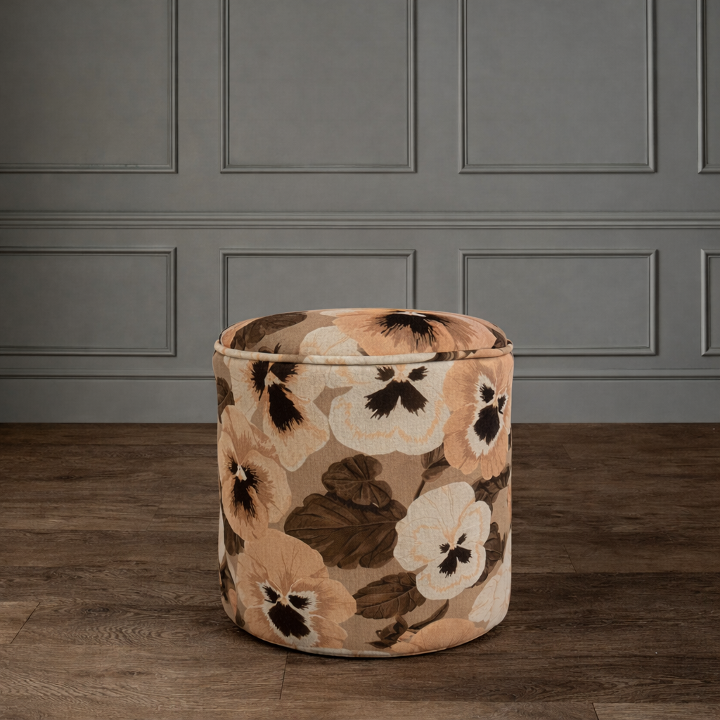 Floral pouffe on wooden floor.png