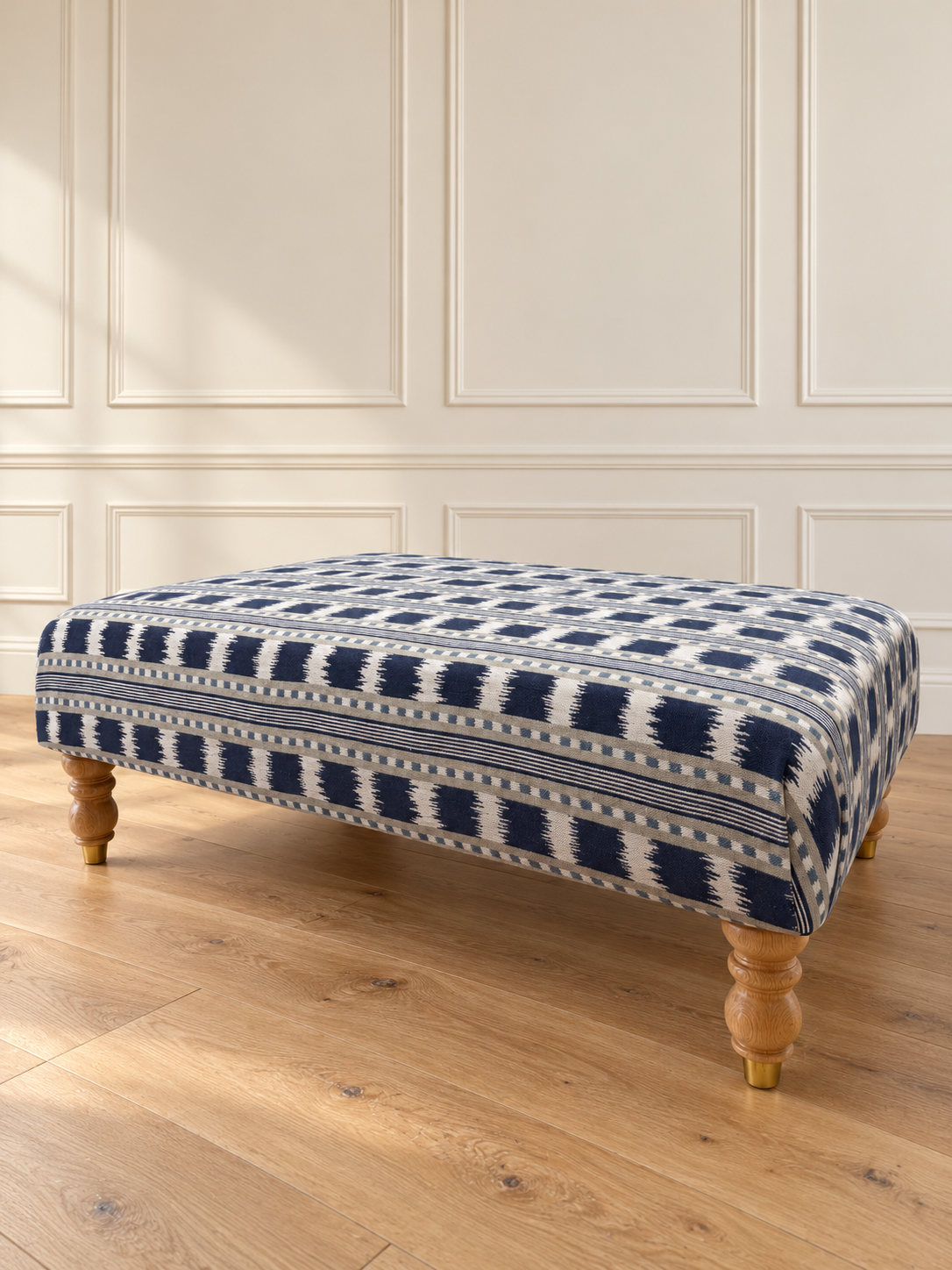 Navy geometric footstool on oak floor.png