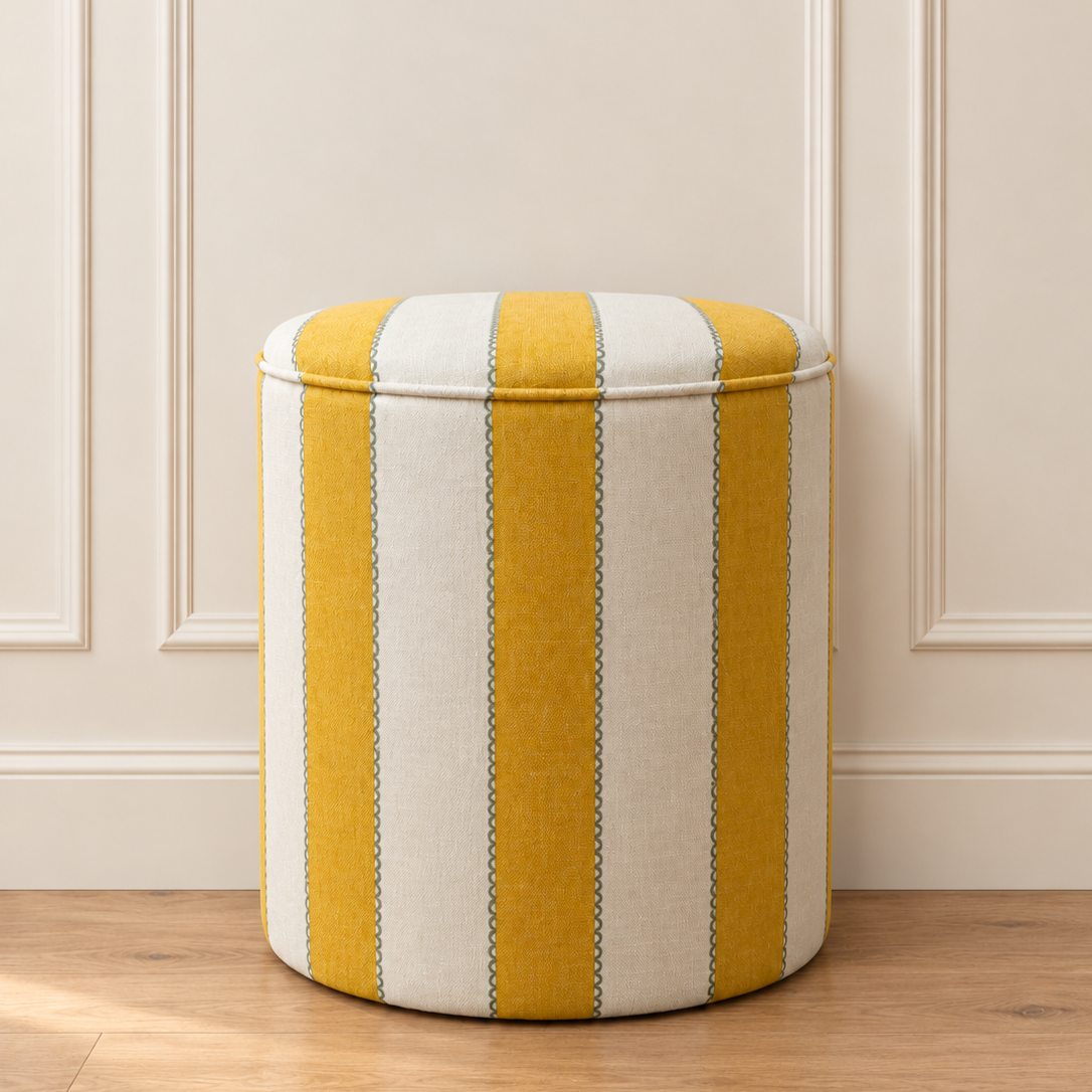 Yellow+striped+pouffe+flush+against+cream+wall.png