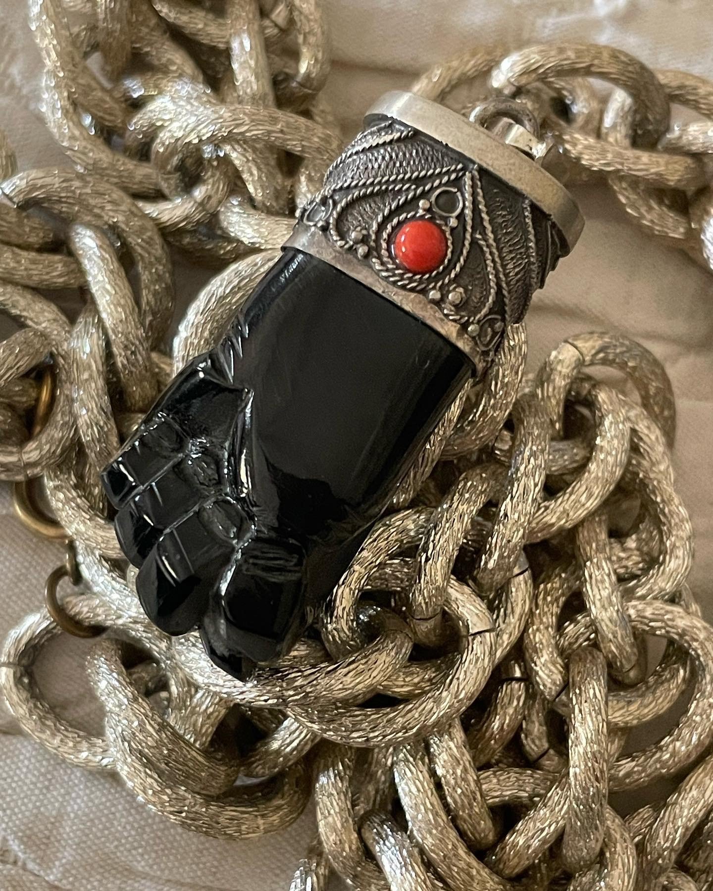 Chunky hand-carved mano figa charm made of azabache, silver and coral. From Rod Mayer in Santiago, Spain. House of Good Fortune Collection.