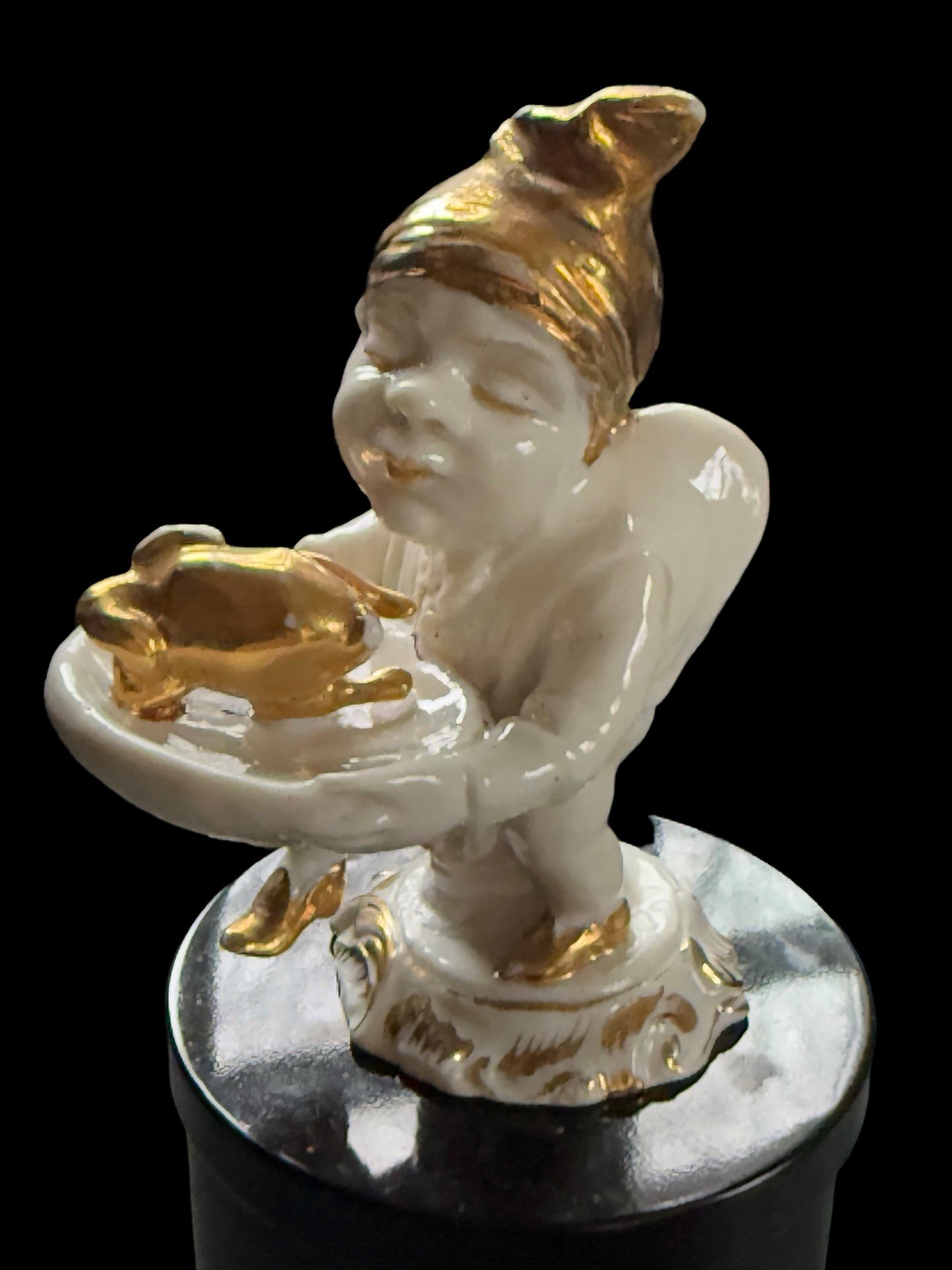 Gobbo figurine with gilt cap, slippers and roasted chicken; House of Good Fortune Collection.