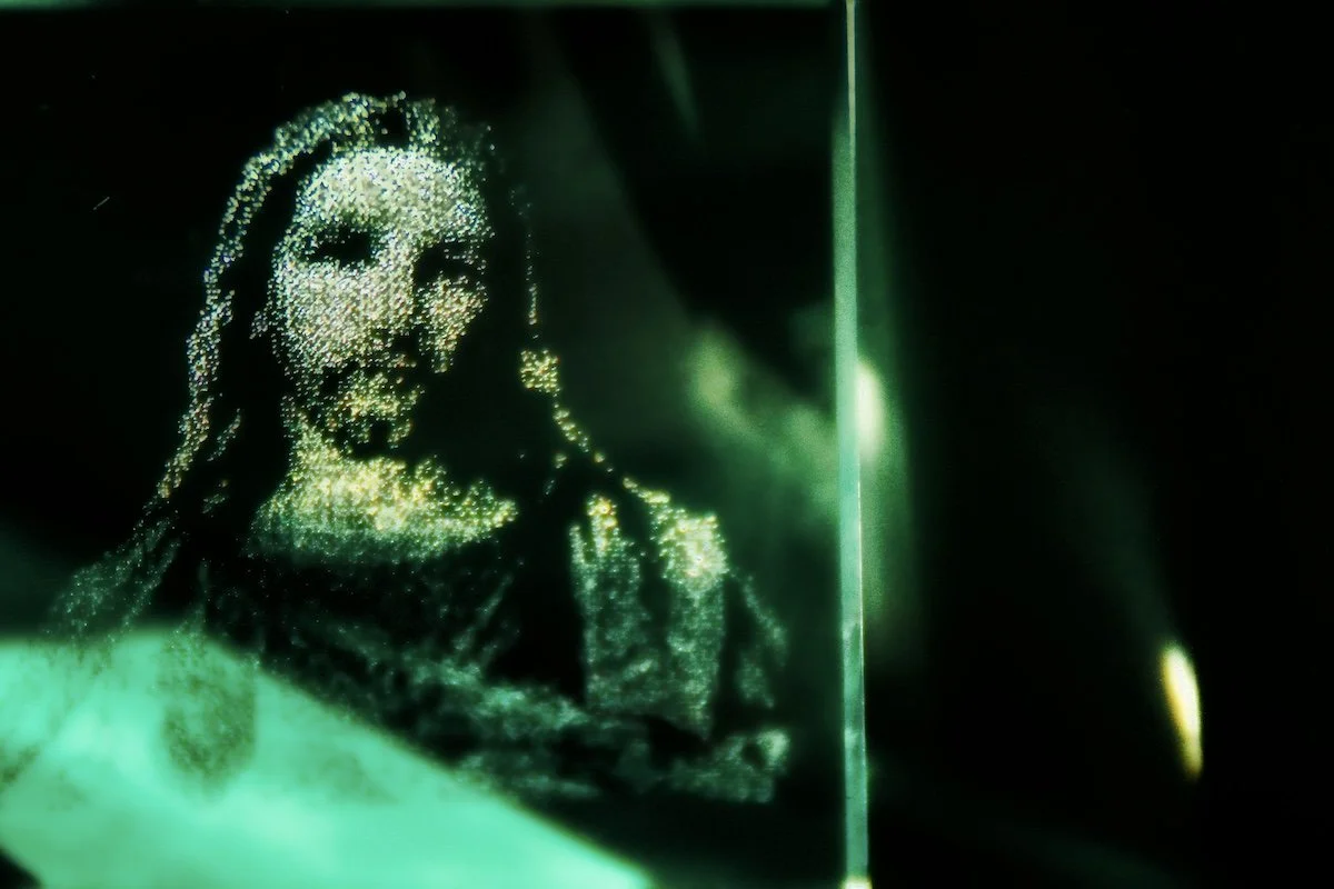 digital green image of Jesus on glass representing Christian living in a modern computer age