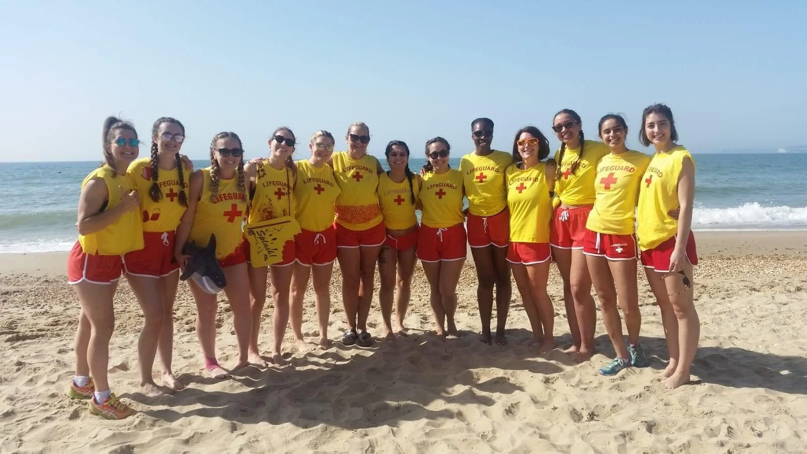 Inglis Netball Club players lined up on Bournemouth Beach following the 2019 Beach Netball Tournament dressed as lifeguards