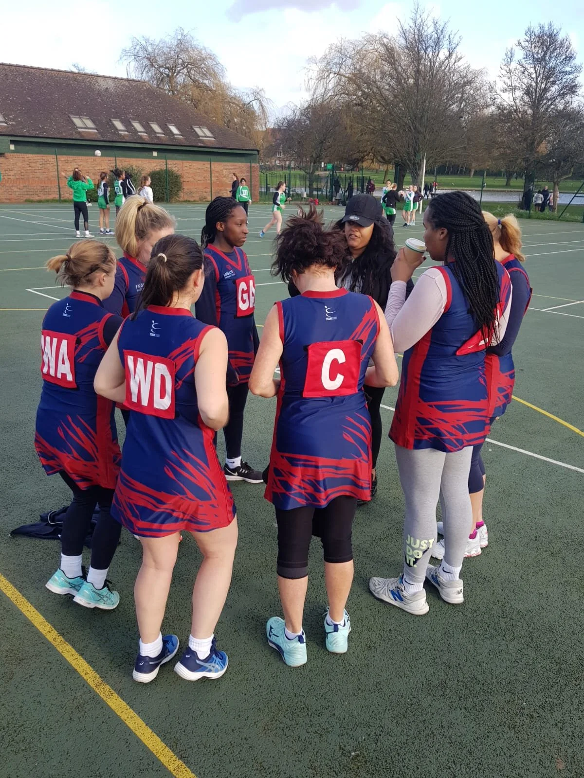 Inglis Netball Club B team during a team huddle at half time