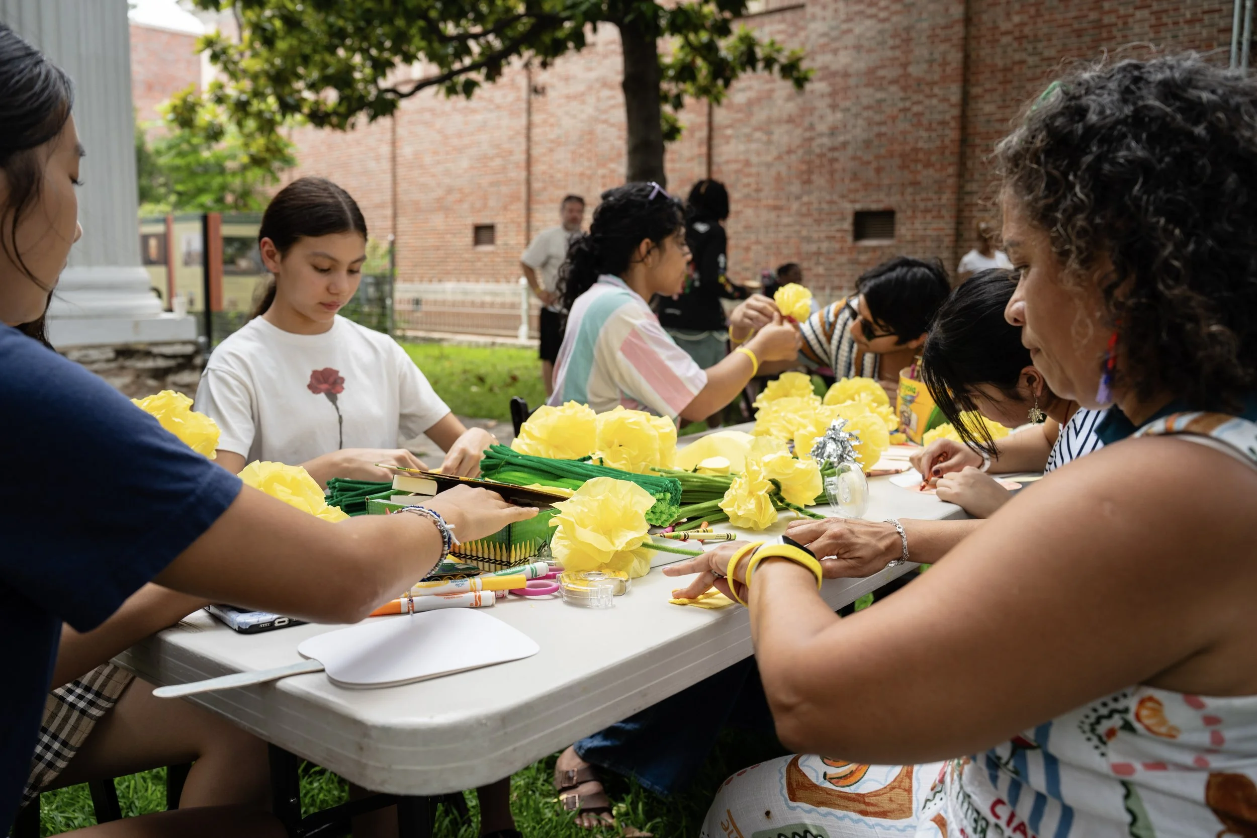 Creating paper flowers for the bench dedication.