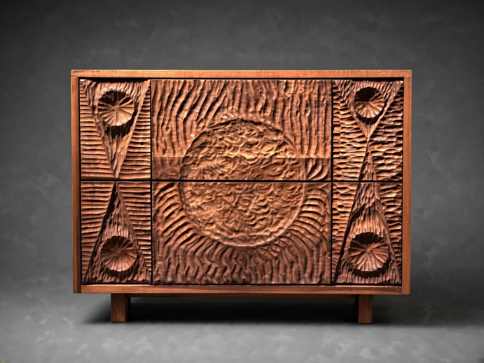 Wooden cabinet with hand carved, geometric patterns on the doors. Made by Wooden Objex. 