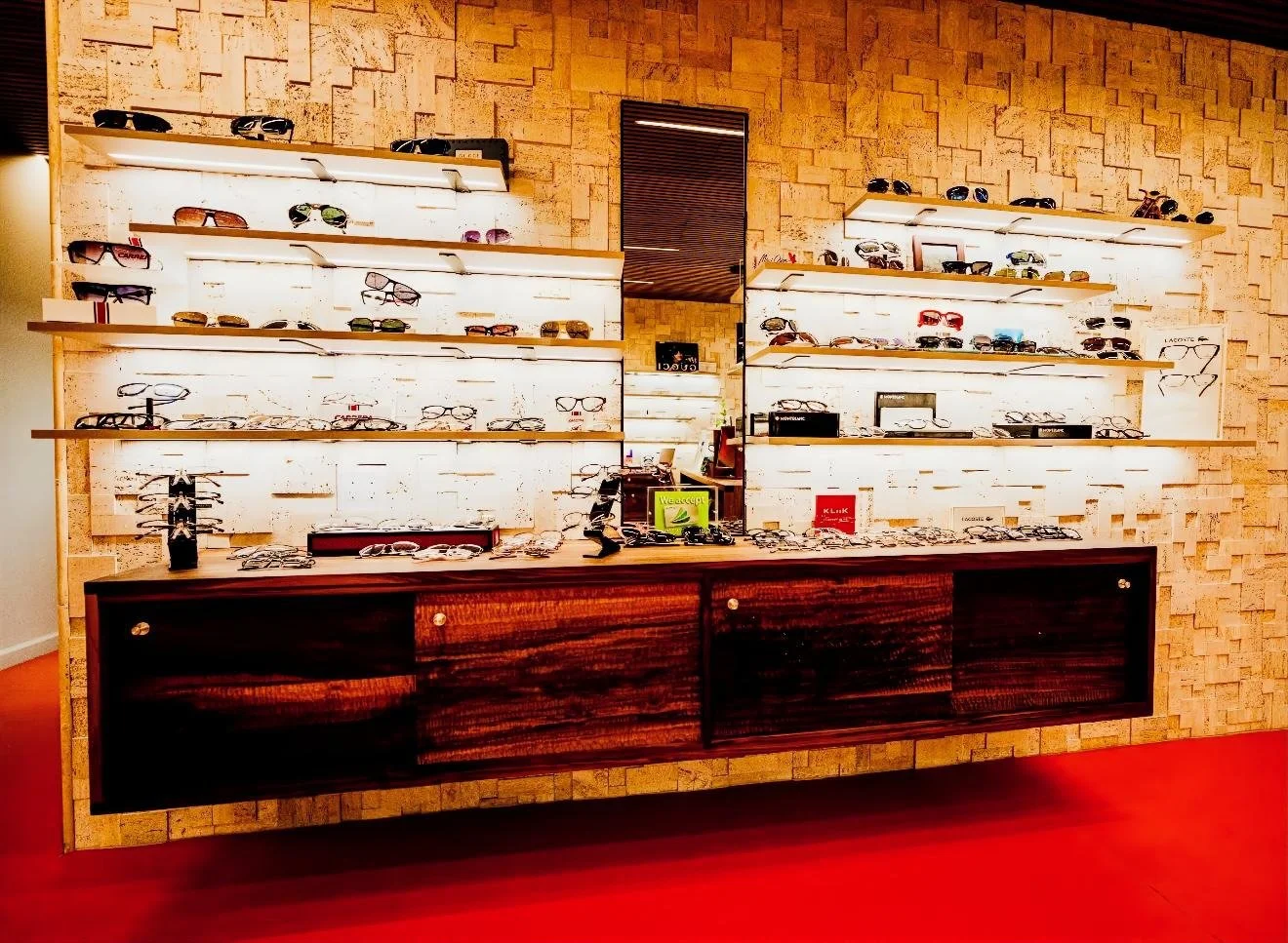Display of sunglasses on white shelves in an optician's store.