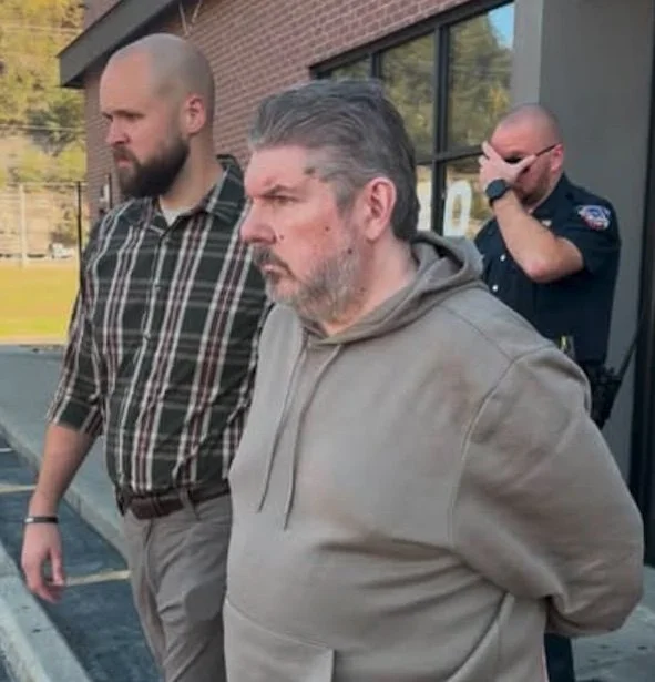 John Carroll being arrested.jpg