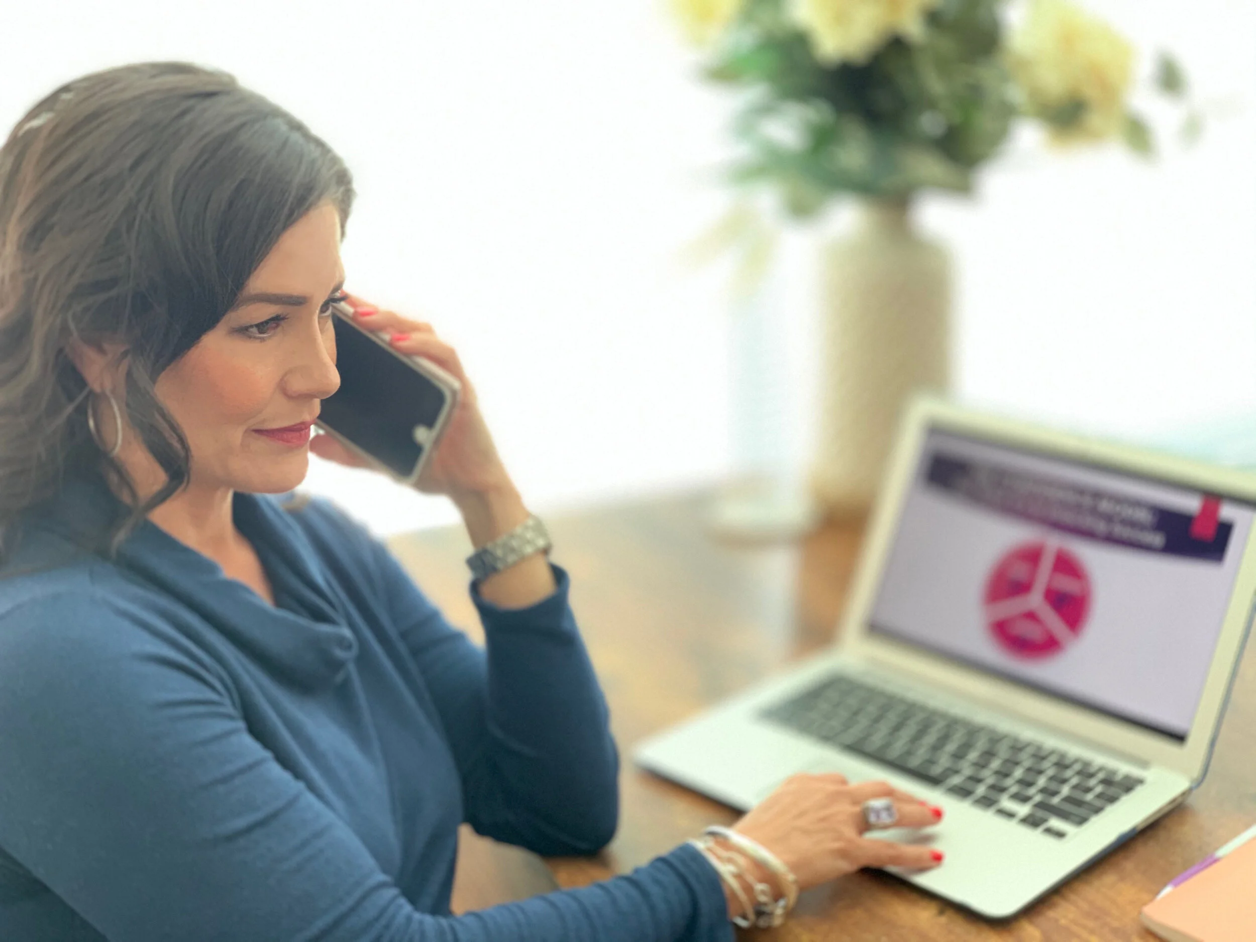 A woman on the phone in her office