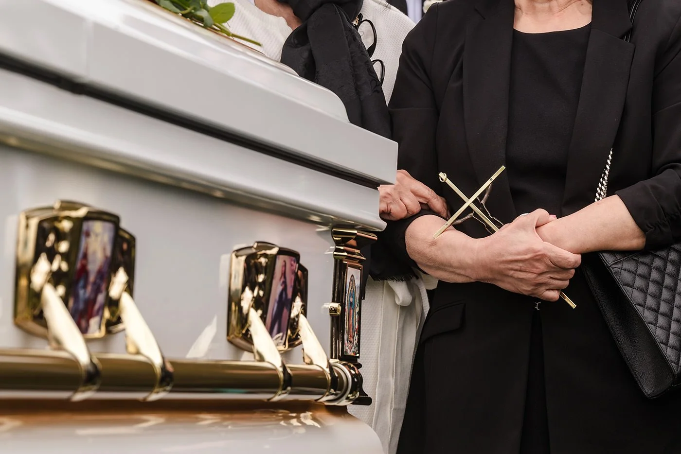 Mourners paying respects at casket during graveside service at Forest Lawn Covina Hills