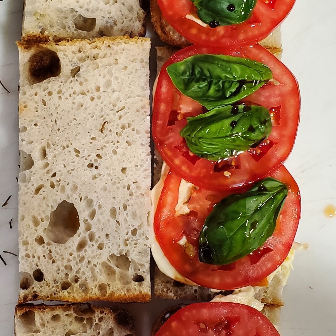 Simple goodness

Our housemade rosemary and olive oil focaccia lathered with fresh mozz Zach made on Tuesday from @nicefarms milk, topped with a bursting red tomato and crisp basil from @redacreshydroponics and finished with a drizzle of EVOO and bal