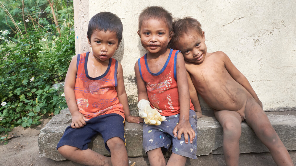  Three friends sitting under the sun. It was heartbreaking to see the boy on the left, with a runny nose and shirt covered with mucus. While I was there, none of his family came to help or clean him up. 
