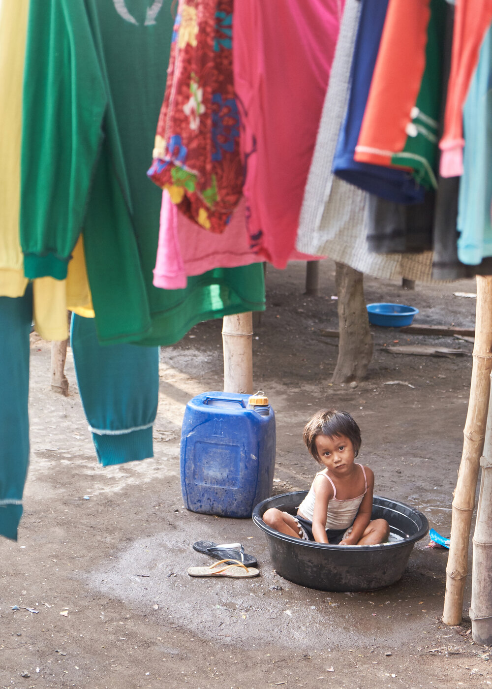  A young Badjao girl playing in a laundry wash bucket. 