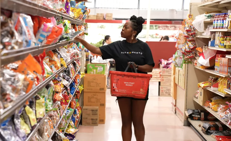 Melissa picking out items in the aisle of a grocery store