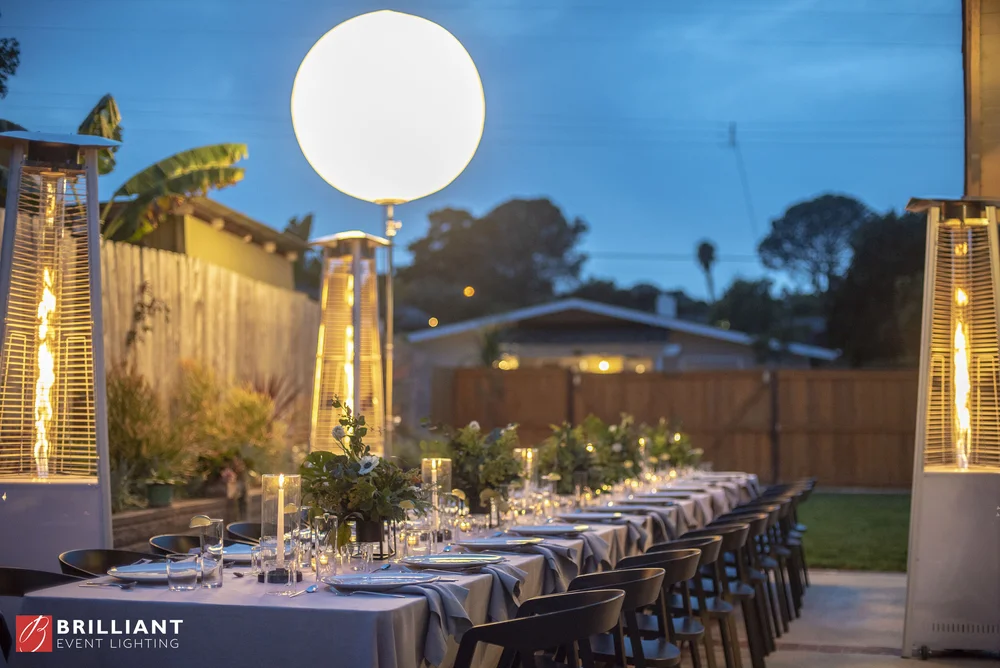 Moon balloon light floating above an outdoor event