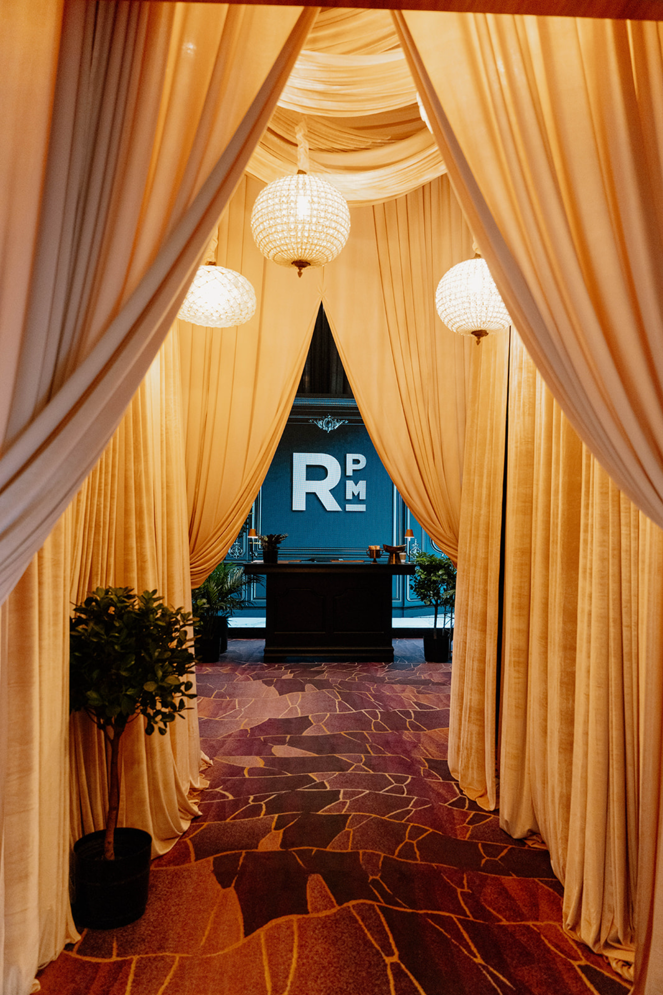 luxury-event-draping-design-rental-las-vegas-rpm-chandelier-draped-hallway.png