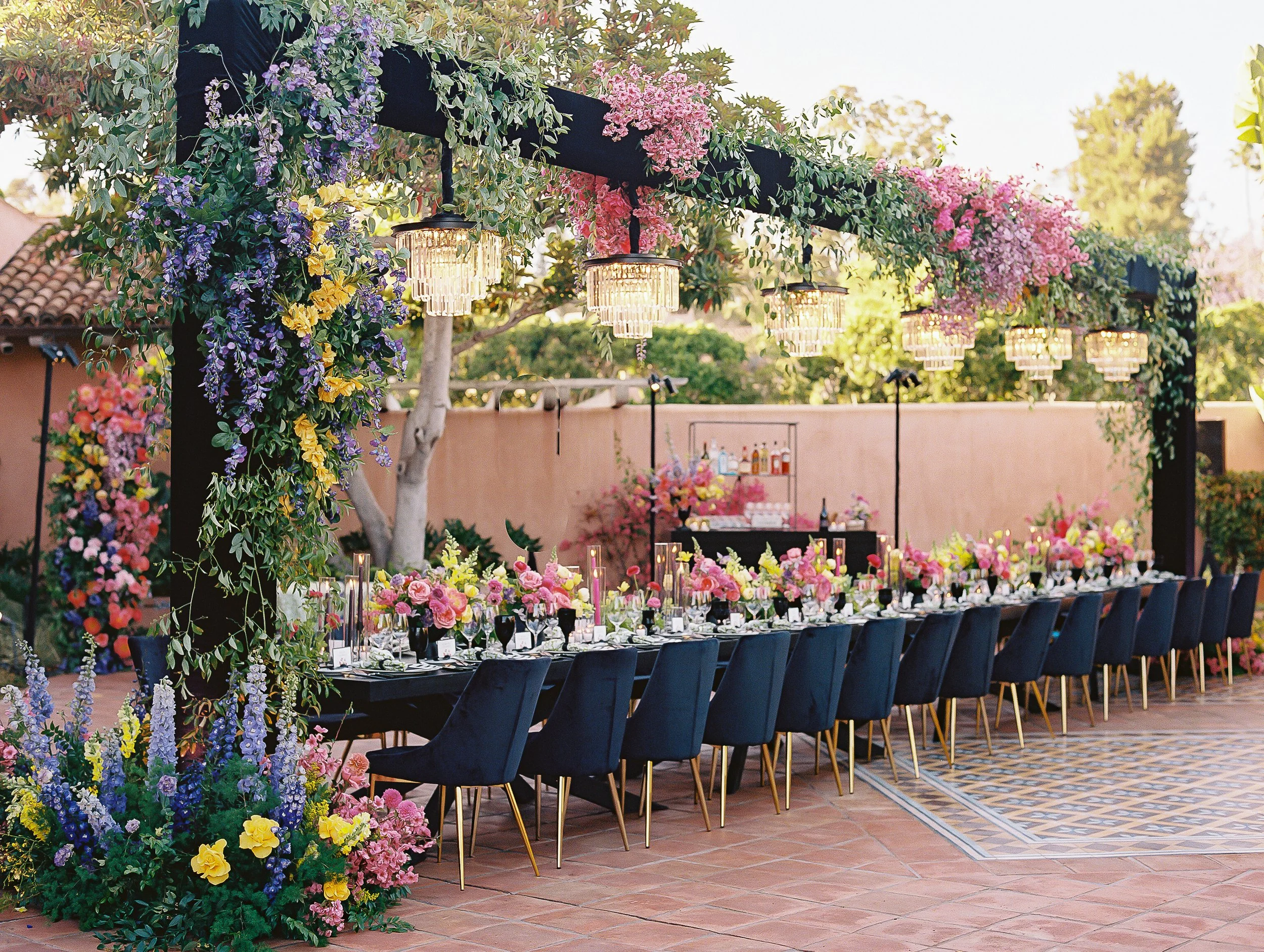 rancho-valencia-wedding-floral-pergola-crystal-chandeliers-navy-chairs.jpg